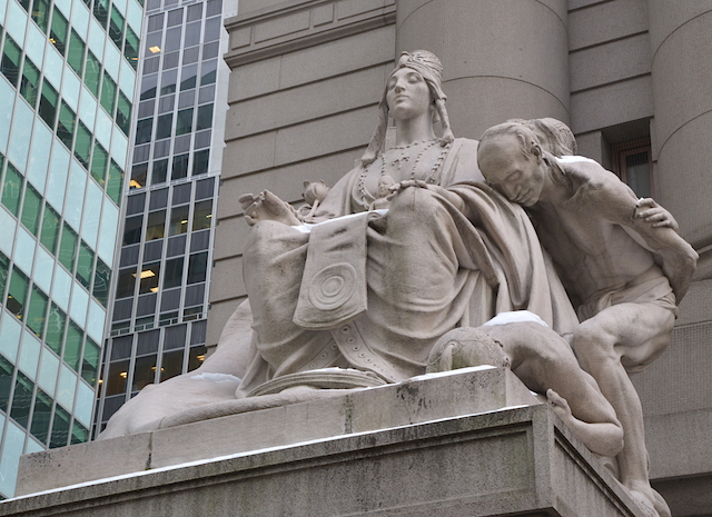 One of the four statues in front of the museum