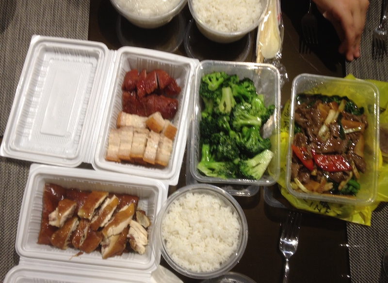Cantonese-style dinner- roast pork and stir-fried vegetables and noodles