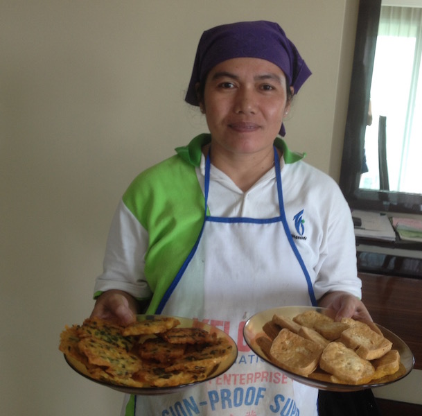 Yati with a plate of tempeh and cucuk bawang