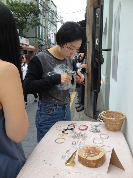 This is Mimi giving my bracelet a final touch at Bukchon Hanok Village